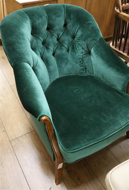 A dark green button back armchair